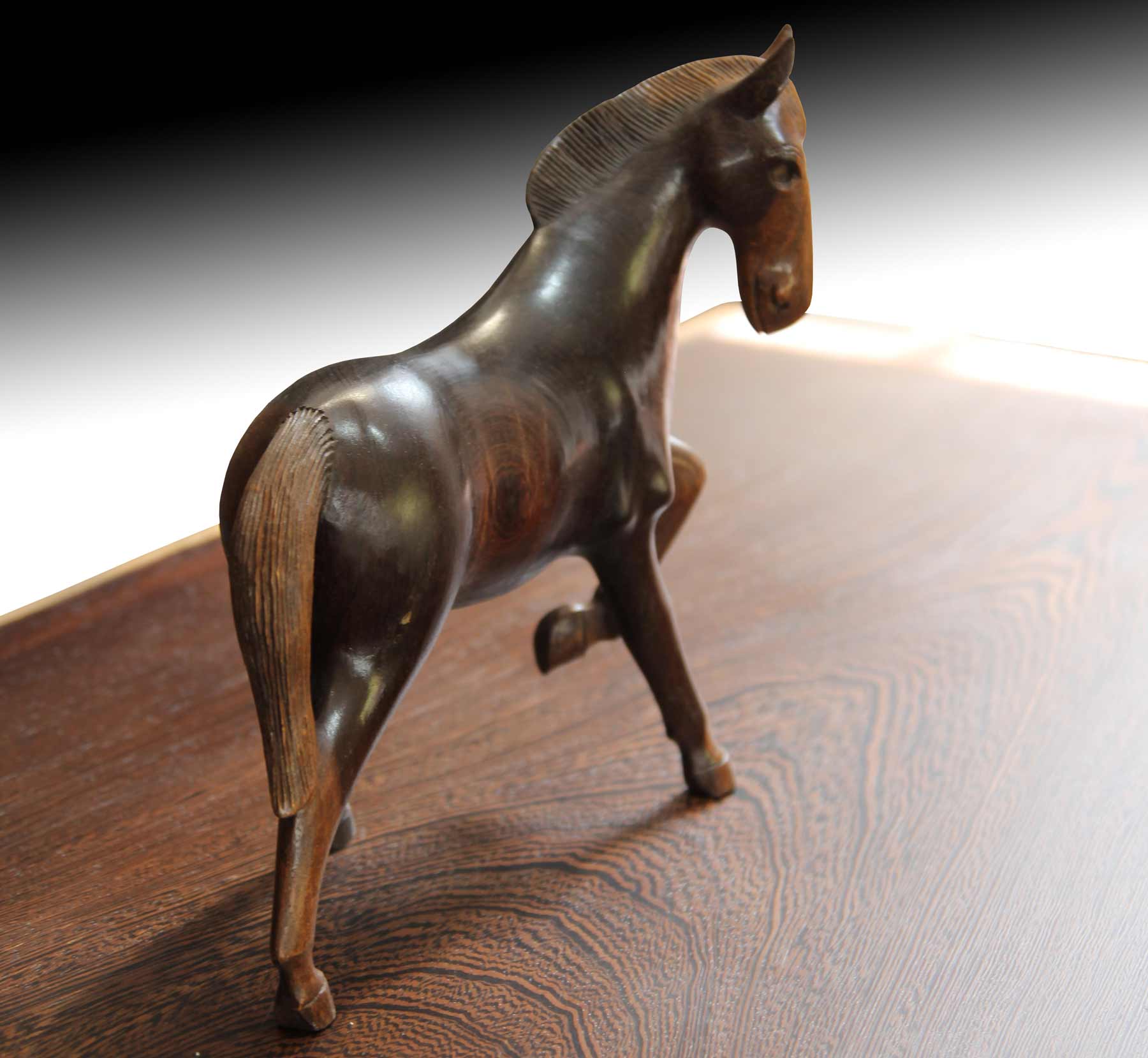Wooden horse figurine on live edge suarwood table